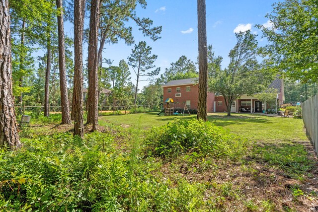 3228 Mcmillan Creek Dr, Milton, FL 32583 - fenced backyard featuring a playground