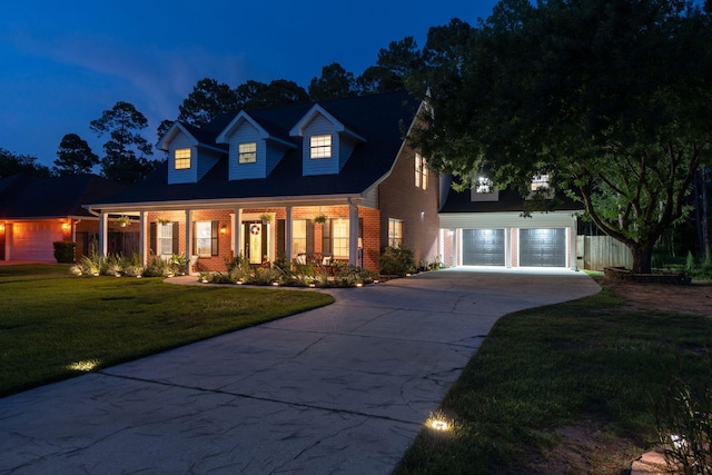 3228 Mcmillan Creek Dr, Milton, FL 32583 - new england style home featuring brick siding, concrete driveway, a yard, an attached garage, and an outbuilding