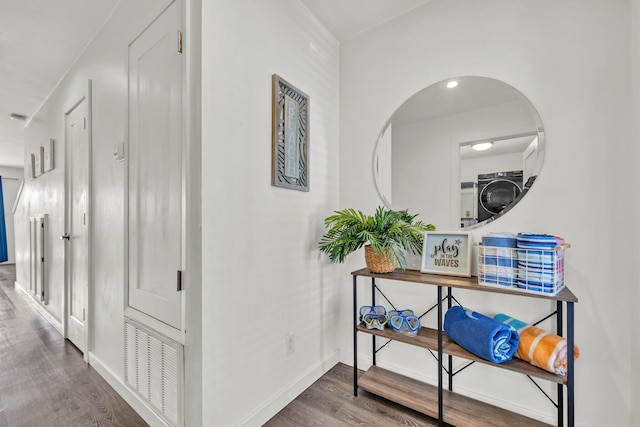 115 Gulf Winds Ct Unit 2, Destin, FL 32541 - hallway featuring stacked washer / drying machine and wood finished floors