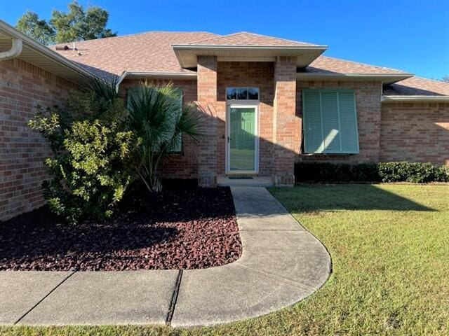 4906 Laurel Oak Dr, Pace, FL 32571 - entrance to property featuring brick siding, a lawn, and roof with shingles