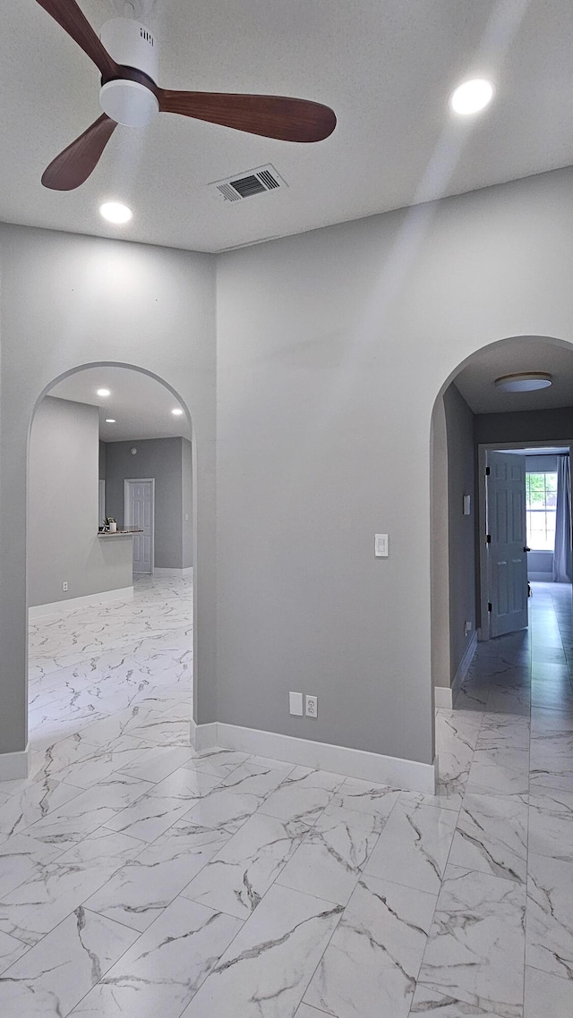 4906 Laurel Oak Dr, Pace, FL 32571 - unfurnished room with arched walkways, ceiling fan, recessed lighting, and marble look tile flooring