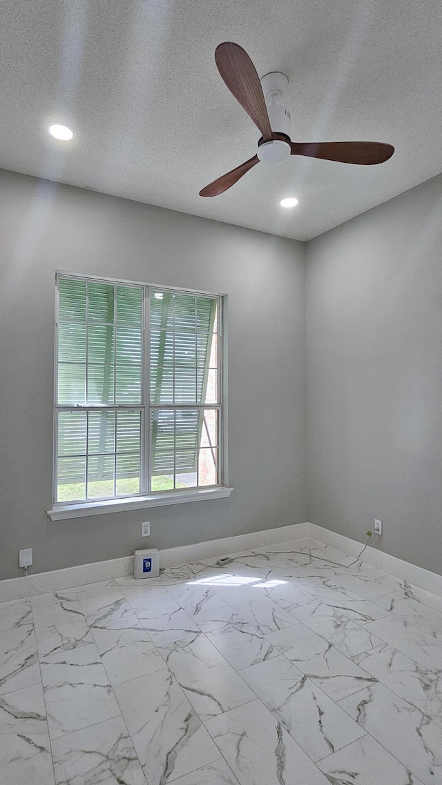 4906 Laurel Oak Dr, Pace, FL 32571 - empty room with ceiling fan, healthy amount of natural light, recessed lighting, marble finish floors, and a textured ceiling