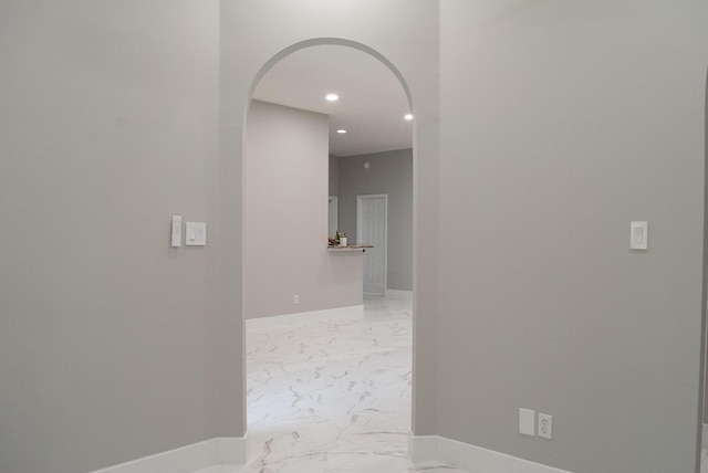4906 Laurel Oak Dr, Pace, FL 32571 - hallway featuring arched walkways, light marble finish flooring, and recessed lighting