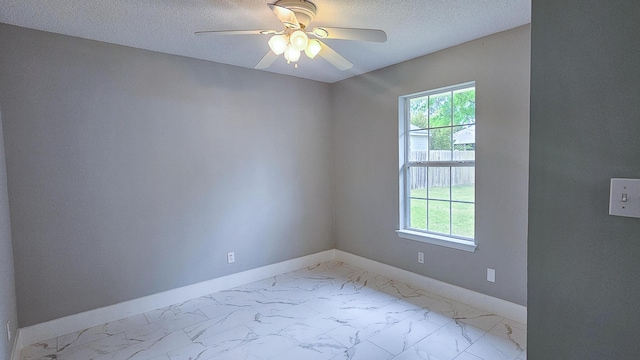 4906 Laurel Oak Dr, Pace, FL 32571 - spare room with healthy amount of natural light, light marble finish floors, ceiling fan, and a textured ceiling