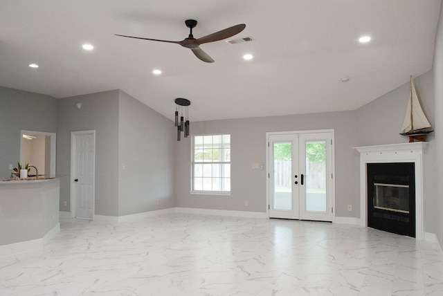 4906 Laurel Oak Dr, Pace, FL 32571 - unfurnished living room with ceiling fan, recessed lighting, french doors, a glass covered fireplace, and light marble finish floors