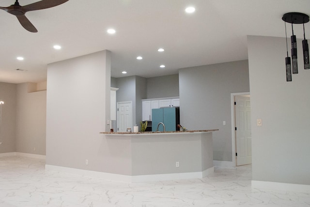 4906 Laurel Oak Dr, Pace, FL 32571 - kitchen featuring freestanding refrigerator, light marble finish floors, ceiling fan, recessed lighting, and white cabinets
