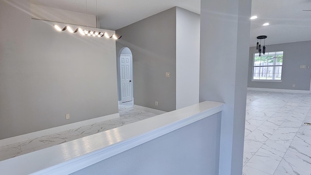 4906 Laurel Oak Dr, Pace, FL 32571 - hall featuring marble finish flooring, arched walkways, and recessed lighting