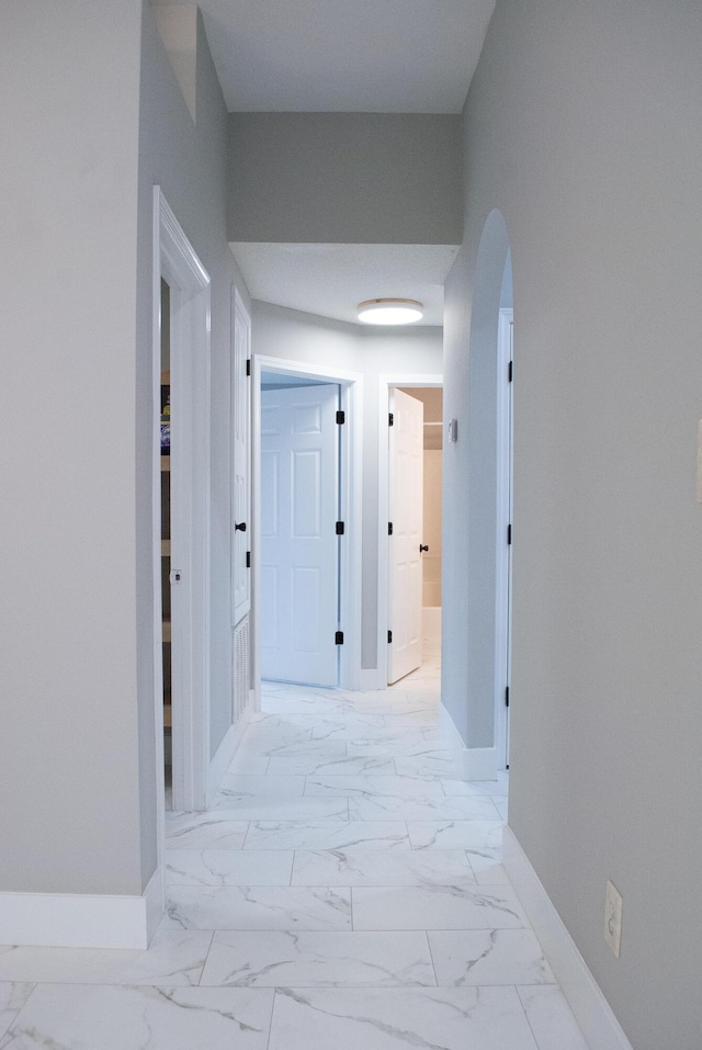 4906 Laurel Oak Dr, Pace, FL 32571 - hall featuring arched walkways and light marble finish floors