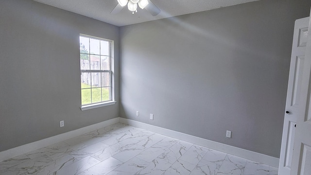 4906 Laurel Oak Dr, Pace, FL 32571 - unfurnished room with ceiling fan, light marble finish floors, and a textured ceiling