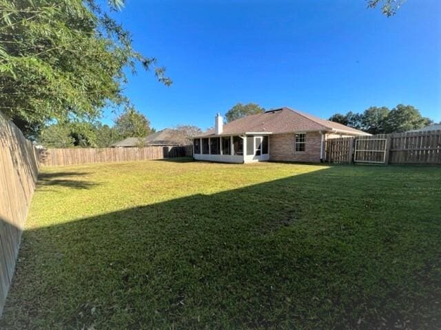4906 Laurel Oak Dr, Pace, FL 32571 - fenced backyard featuring a sunroom