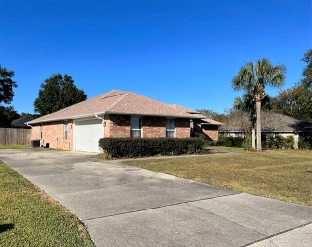 4906 Laurel Oak Dr, Pace, FL 32571 - view of front of house featuring a garage, a front lawn, concrete driveway, and brick siding
