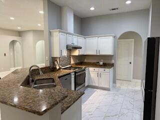 4906 Laurel Oak Dr, Pace, FL 32571 - kitchen with arched walkways, electric range, a peninsula, range hood, and recessed lighting