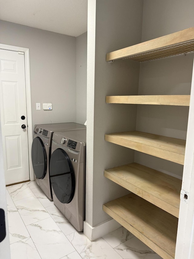 4906 Laurel Oak Dr, Pace, FL 32571 - laundry room with marble look tile flooring and washer and clothes dryer
