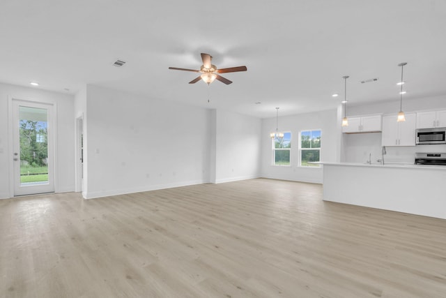 785 Alleyoak Ln Lot 86-1, Freeport, FL 32439 - unfurnished living room with recessed lighting, light wood-style floors, ceiling fan, and a chandelier