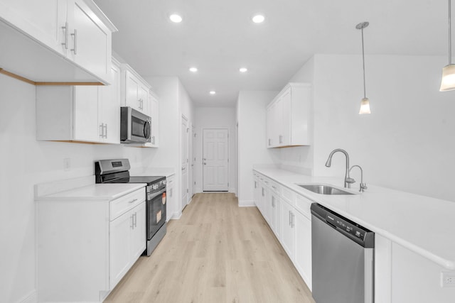 785 Alleyoak Ln Lot 86-1, Freeport, FL 32439 - kitchen featuring stainless steel appliances, light wood-style floors, light countertops, recessed lighting, and white cabinetry