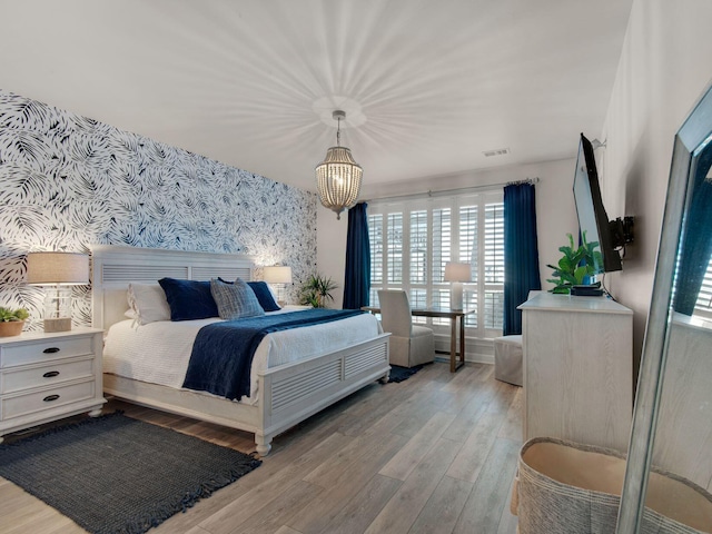 9815 W US Highway 98 Unit 48, Miramar Beach, FL 32550 - bedroom with wallpapered walls, multiple windows, and light wood-type flooring