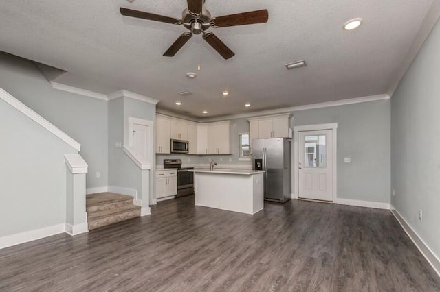 151 N Sand Palm Rd Unit 151, Freeport, FL 32439 - kitchen with appliances with stainless steel finishes, open floor plan, a ceiling fan, crown molding, and light countertops