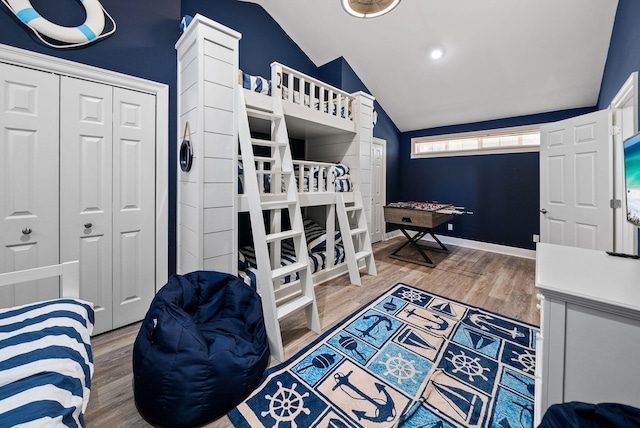 72 Vantage Pt, Miramar Beach, FL 32550 - bedroom with vaulted ceiling, wood finished floors, and a closet