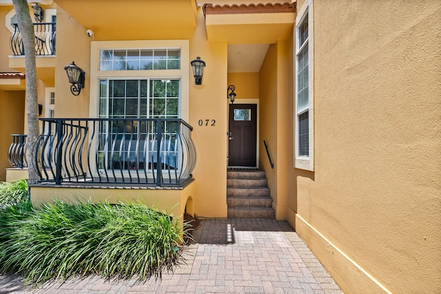 72 Vantage Pt, Miramar Beach, FL 32550 - entrance to property with stucco siding, a surveillance system, and a tile roof