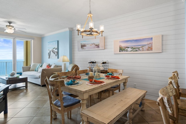 17643 Front Beach Rd Unit 1905, Panama City Beach, FL 32413 - dining room featuring a chandelier, crown molding, a textured ceiling, ceiling fan, and light tile patterned flooring