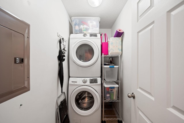 17643 Front Beach Rd Unit 1905, Panama City Beach, FL 32413 - laundry area featuring estacked washer and dryer, electric panel, and a textured ceiling