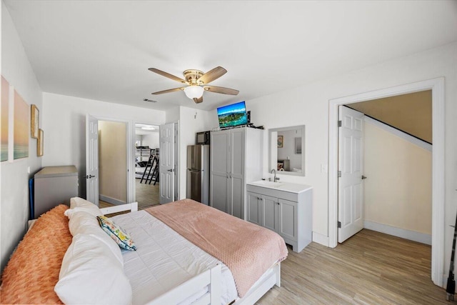 926 Whelk Ct Unit C, Fort Walton Beach, FL 32548 - bedroom with freestanding refrigerator, light wood-type flooring, and a ceiling fan