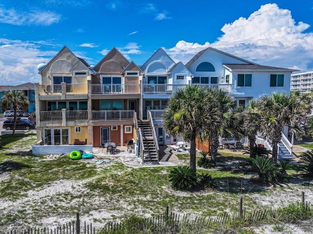 926 Whelk Ct Unit C, Fort Walton Beach, FL 32548 - rear view of property featuring a patio, stucco siding, a balcony, and stairs