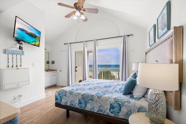 926 Whelk Ct Unit C, Fort Walton Beach, FL 32548 - bedroom with access to exterior, light wood finished floors, vaulted ceiling, ensuite bathroom, and a water view