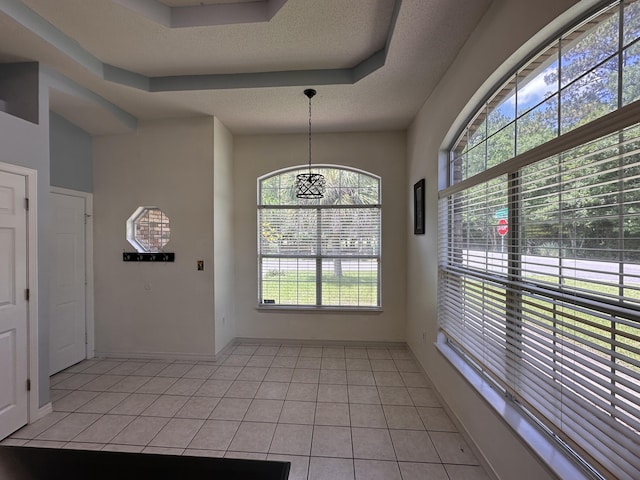 1174 Witshire Ct, Fort Walton Beach, FL 32547 - unfurnished dining area with light tile patterned floors, a chandelier, and a textured ceiling