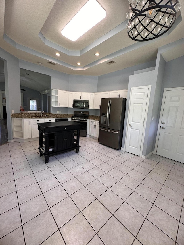 1174 Witshire Ct, Fort Walton Beach, FL 32547 - kitchen featuring appliances with stainless steel finishes, a raised ceiling, dark countertops, white cabinets, and recessed lighting
