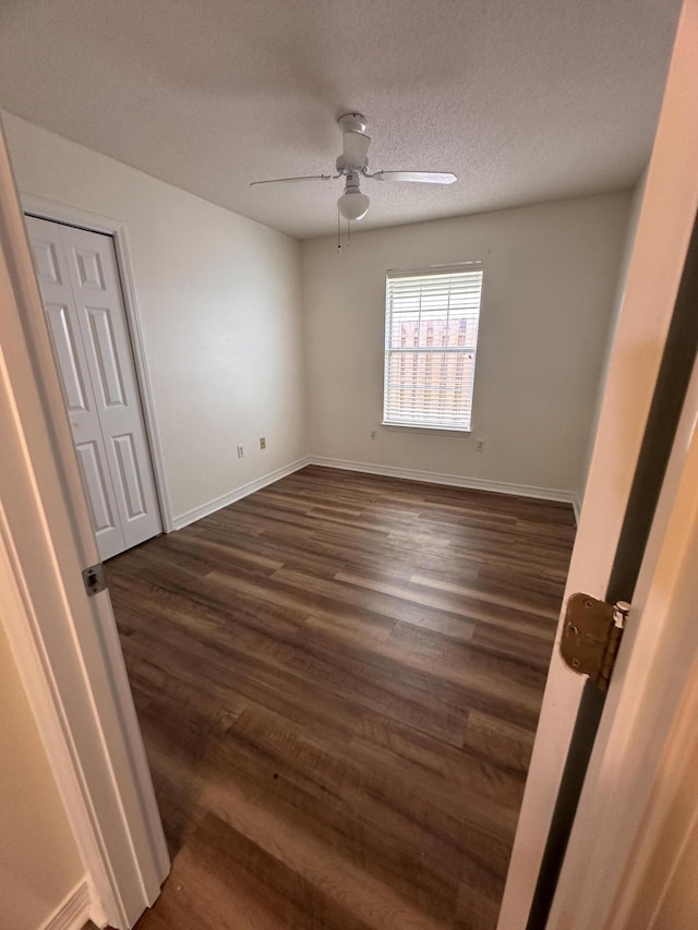 1174 Witshire Ct, Fort Walton Beach, FL 32547 - empty room with ceiling fan, dark wood finished floors, and a textured ceiling
