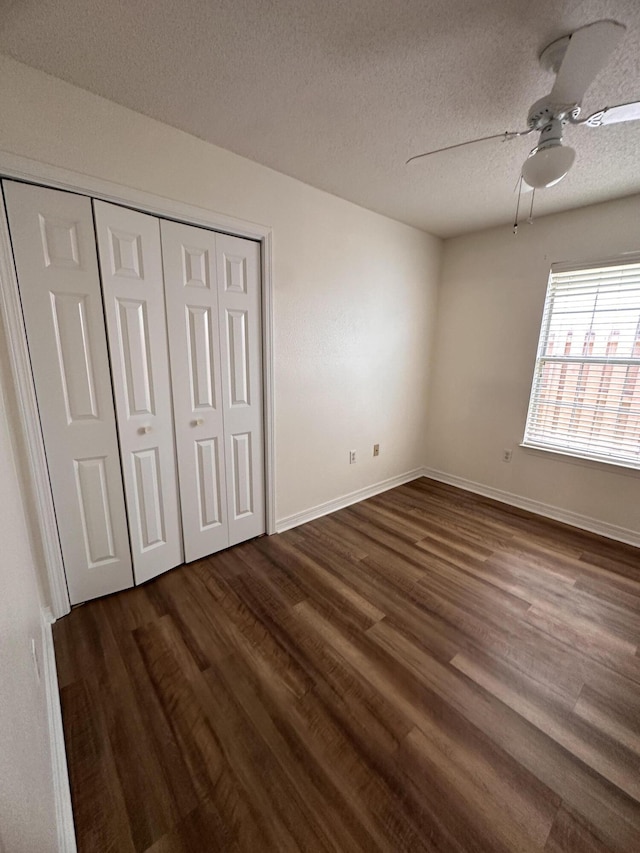 1174 Witshire Ct, Fort Walton Beach, FL 32547 - unfurnished bedroom featuring dark wood-style flooring, a textured ceiling, a closet, and ceiling fan