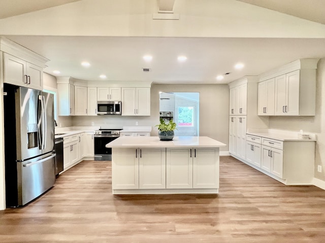 16 N 1st St, Defuniak Springs, FL 32433 - kitchen featuring stainless steel appliances, light wood-style flooring, a kitchen island, light countertops, and recessed lighting