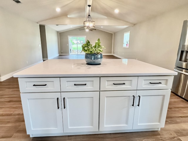 16 N 1st St, Defuniak Springs, FL 32433 - kitchen with stainless steel fridge with ice dispenser, a ceiling fan, white cabinetry, open floor plan, and a kitchen island