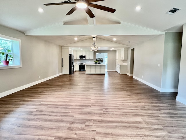16 N 1st St, Defuniak Springs, FL 32433 - unfurnished living room featuring vaulted ceiling, ceiling fan, wood finished floors, and recessed lighting