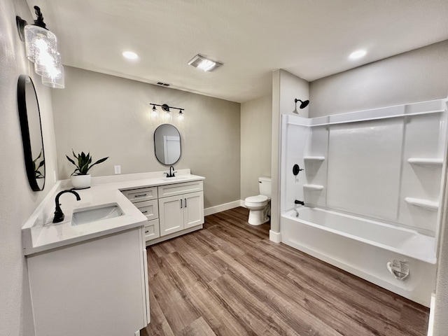 16 N 1st St, Defuniak Springs, FL 32433 - bathroom with vanity, wood finished floors,  shower combination, and recessed lighting