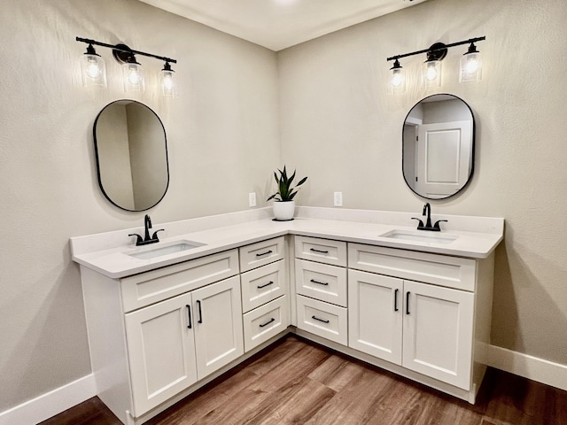16 N 1st St, Defuniak Springs, FL 32433 - bathroom featuring double vanity and wood finished floors
