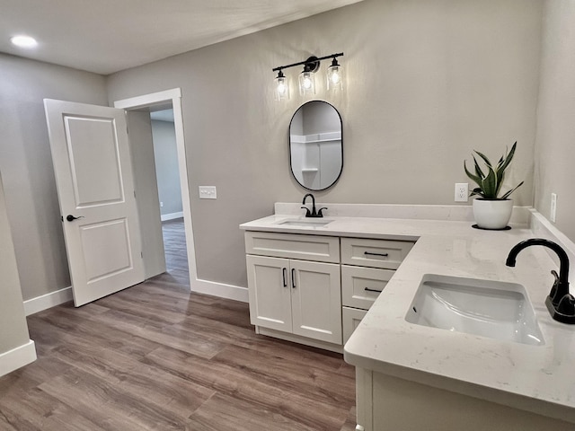 16 N 1st St, Defuniak Springs, FL 32433 - bathroom with double vanity and wood finished floors