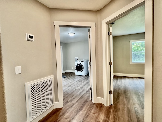 16 N 1st St, Defuniak Springs, FL 32433 - hall featuring washer / dryer and wood finished floors