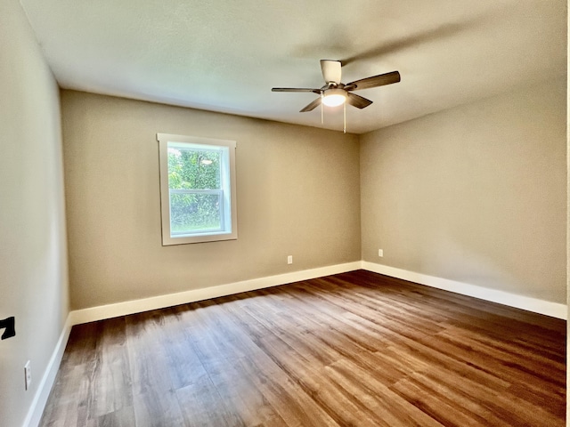 16 N 1st St, Defuniak Springs, FL 32433 - empty room with ceiling fan and wood finished floors