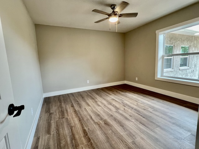 16 N 1st St, Defuniak Springs, FL 32433 - unfurnished room featuring wood finished floors and ceiling fan