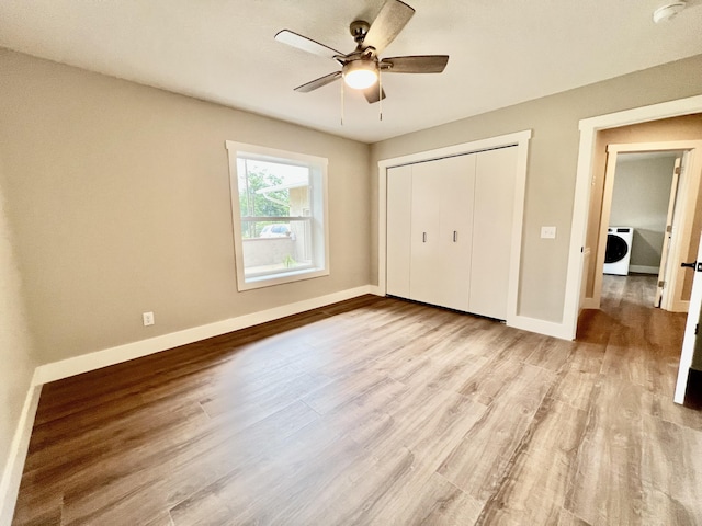16 N 1st St, Defuniak Springs, FL 32433 - unfurnished bedroom featuring washer / dryer, light wood-type flooring, a closet, and a ceiling fan