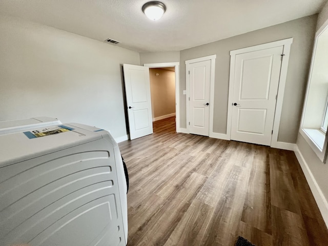 16 N 1st St, Defuniak Springs, FL 32433 - unfurnished bedroom with wood finished floors and washer / dryer