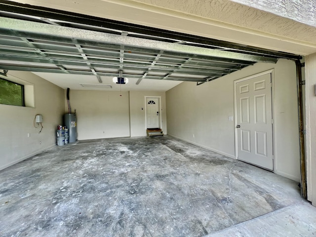 16 N 1st St, Defuniak Springs, FL 32433 - garage featuring electric water heater and a garage door opener