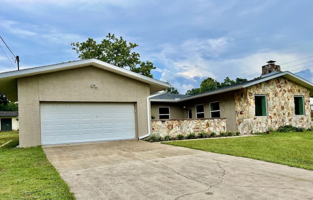 16 N 1st St, Defuniak Springs, FL 32433 - mid-century modern home with stucco siding, stone siding, a front yard, concrete driveway, and an attached garage