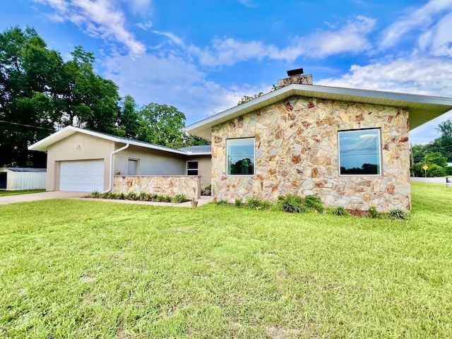 16 N 1st St, Defuniak Springs, FL 32433 - view of front facade featuring stone siding, a chimney, a front lawn, a garage, and driveway