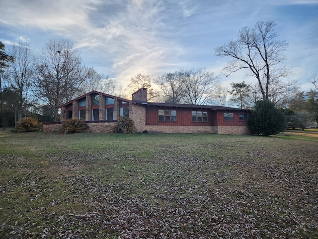 5131 Wiggins Lake Rd, Walnut Hill, FL 32568 - mid-century home with a chimney and a front lawn