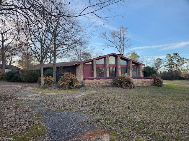 5131 Wiggins Lake Rd, Walnut Hill, FL 32568 - view of home's exterior featuring brick siding and a yard