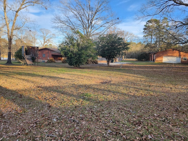 5131 Wiggins Lake Rd, Walnut Hill, FL 32568 - view of green lawn with a garage