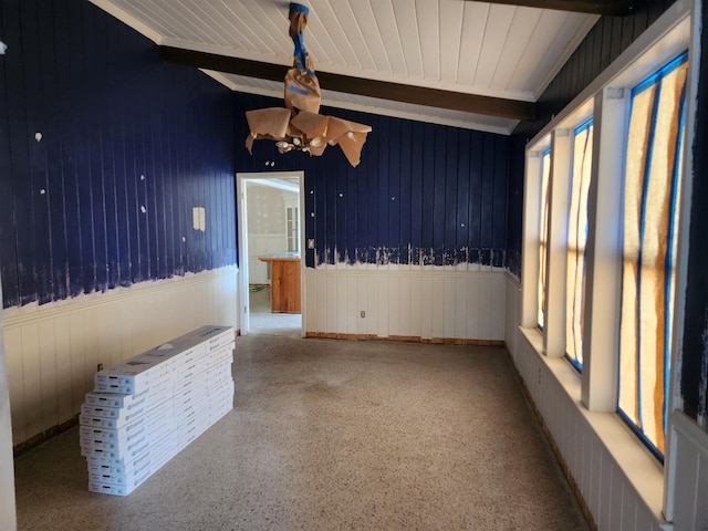 5131 Wiggins Lake Rd, Walnut Hill, FL 32568 - spare room featuring beam ceiling and a wainscoted wall